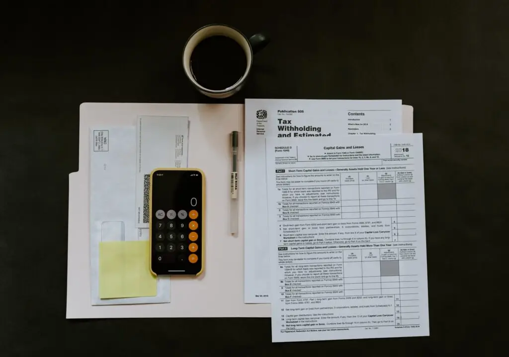 a calculator pen and papers on a desk