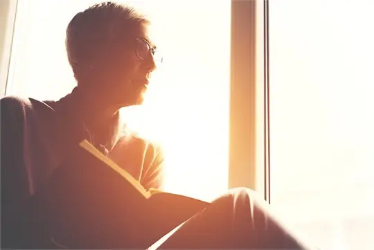 a man sitting in front of a window