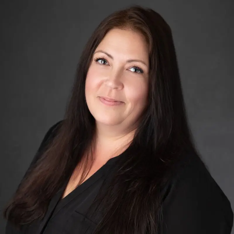 a woman with long hair wearing a black shirt